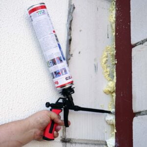 a hand holding a foam gun